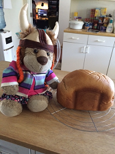 A stuffed lion with a loaf of home-baked bread