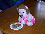 A Stuffed lion with a bagel