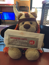 A stuffed lion holding a taco