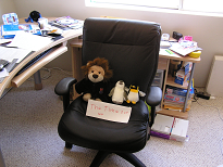 A stuffed lion and two stuffed penguins