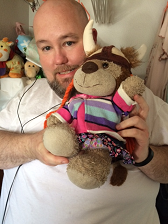 A man holding a stuffed lion