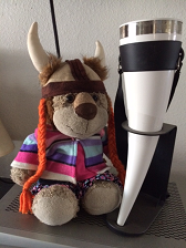 A stuffed lion next to a drinking horn